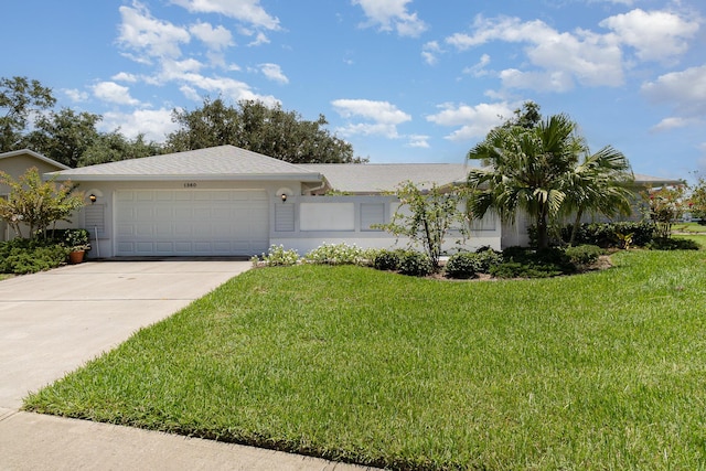 ranch-style home with concrete driveway, a front lawn, an attached garage, and stucco siding