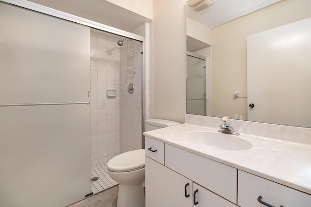 bathroom featuring a stall shower, visible vents, toilet, tile patterned flooring, and vanity