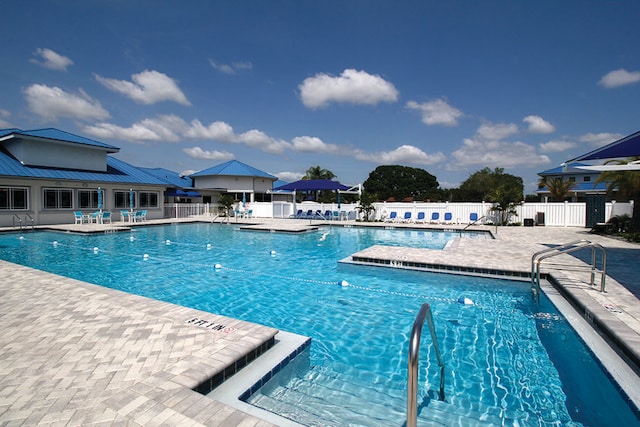 pool featuring a patio and fence