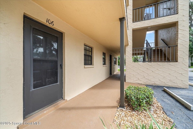 entrance to property with stucco siding