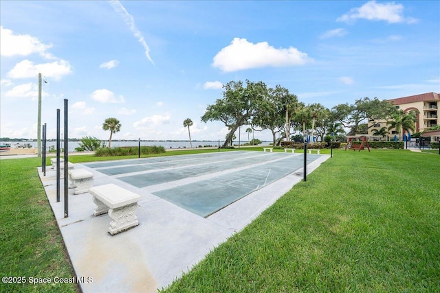 surrounding community featuring shuffleboard and a yard