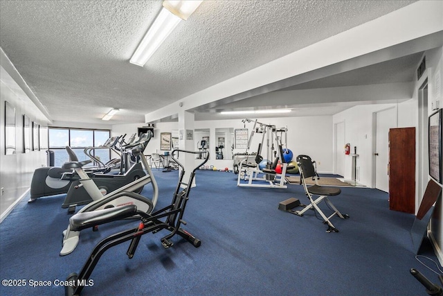 gym featuring a textured ceiling