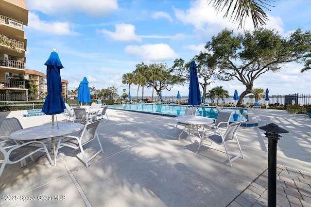 pool featuring a patio area and fence