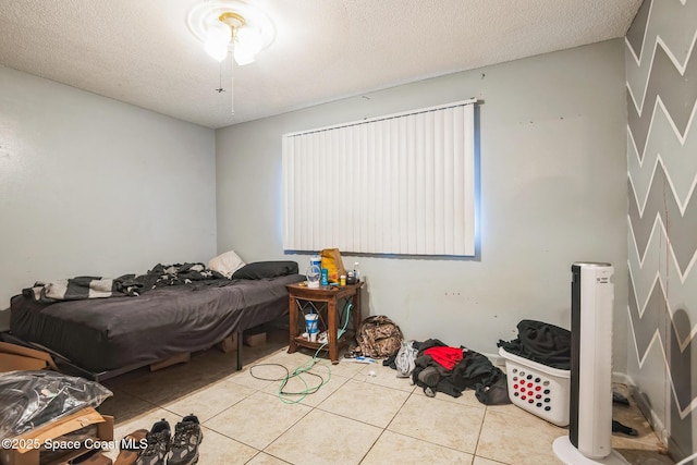 tiled bedroom with a closet and a textured ceiling