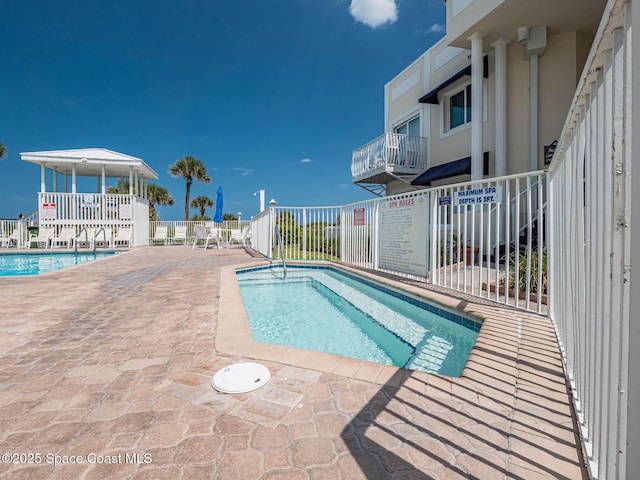 community pool with a patio area