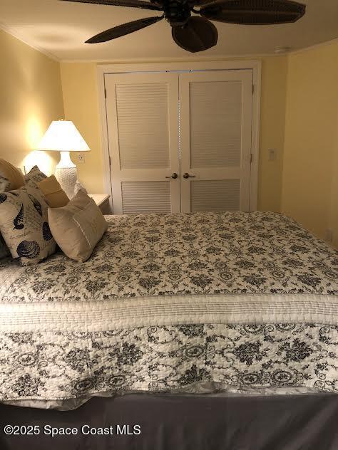 bedroom with ceiling fan and a closet