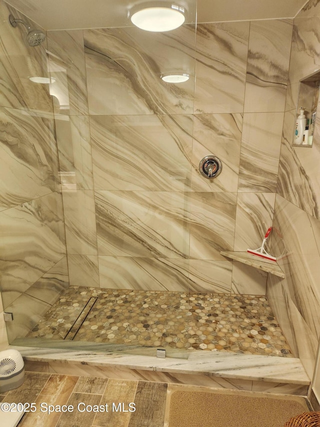 full bath featuring a tile shower