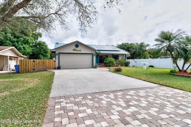 single story home with driveway, an attached garage, fence, and a front yard