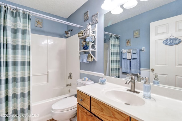 bathroom with shower / bath combination with curtain, a textured ceiling, toilet, and vanity