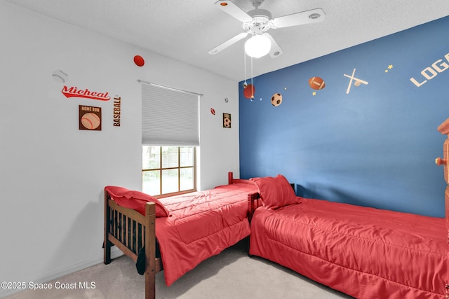carpeted bedroom with a ceiling fan, a textured ceiling, and baseboards