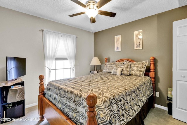 bedroom featuring a textured ceiling, carpet floors, ceiling fan, and baseboards
