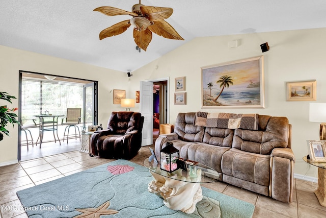 living room with lofted ceiling, ceiling fan, a textured ceiling, and tile patterned flooring