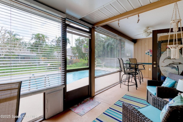 sunroom featuring a ceiling fan