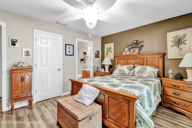 bedroom featuring visible vents, connected bathroom, ceiling fan, a textured ceiling, and light wood-style floors