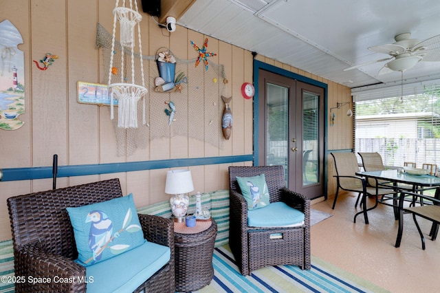 sunroom / solarium with a ceiling fan and french doors