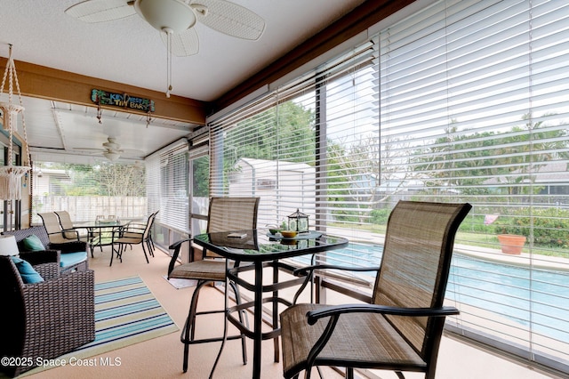 sunroom with a ceiling fan