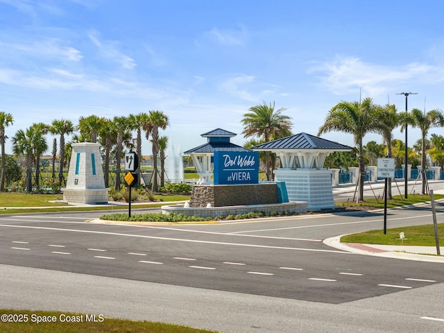 view of road with traffic signs, curbs, and sidewalks