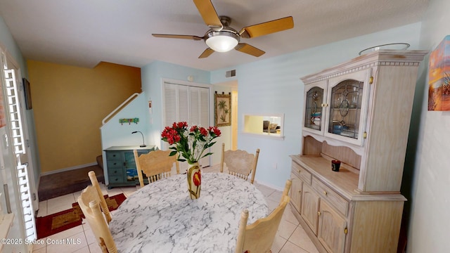 dining area featuring a ceiling fan, light tile patterned floors, baseboards, and visible vents