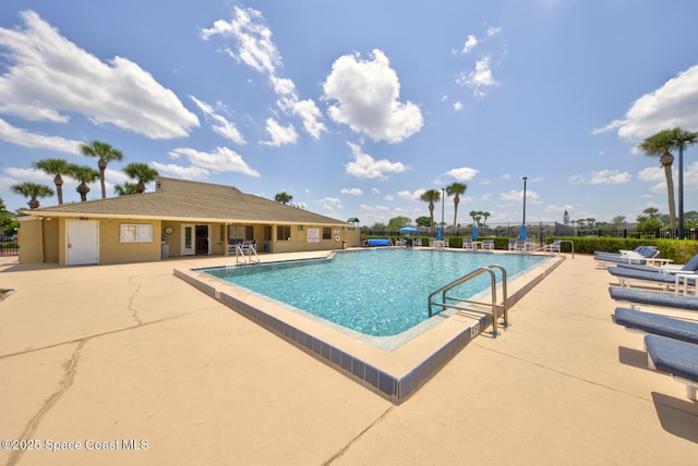 pool featuring a patio area and fence