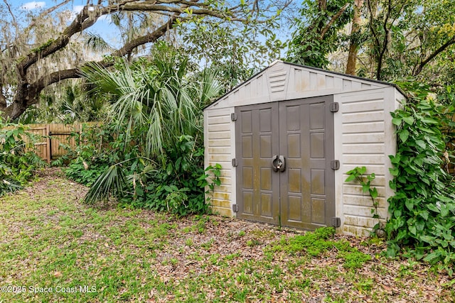 view of shed featuring fence