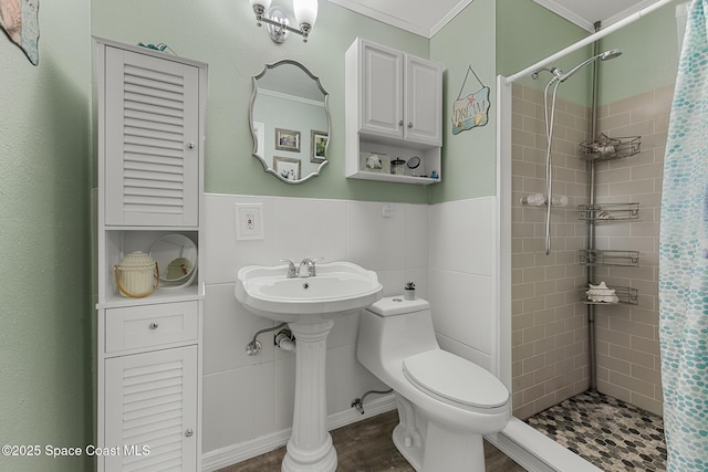 full bathroom featuring wainscoting, a shower stall, toilet, and tile walls