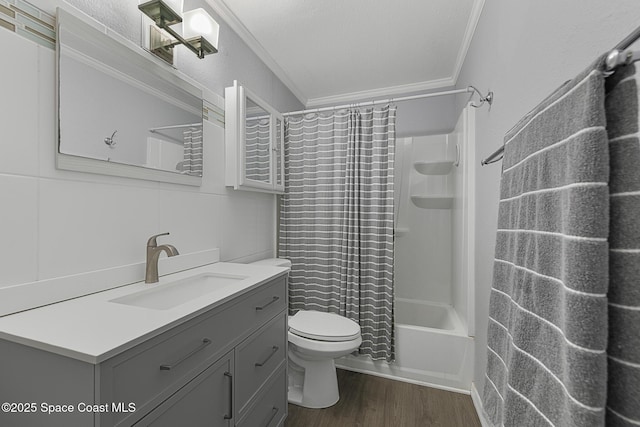 bathroom featuring crown molding, toilet, shower / tub combo, vanity, and wood finished floors