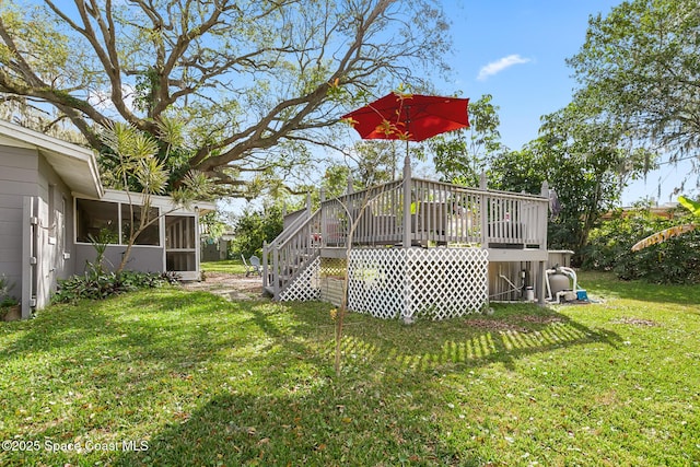 view of yard featuring a sunroom, stairway, and a wooden deck