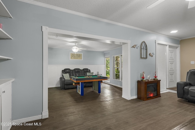 recreation room featuring ornamental molding, ceiling fan, a textured ceiling, wood finished floors, and billiards