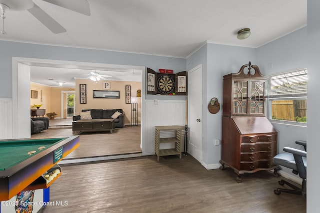 game room featuring ornamental molding, wainscoting, ceiling fan, and wood finished floors