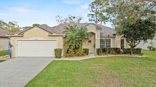 view of front facade with a garage, concrete driveway, a front lawn, and stucco siding