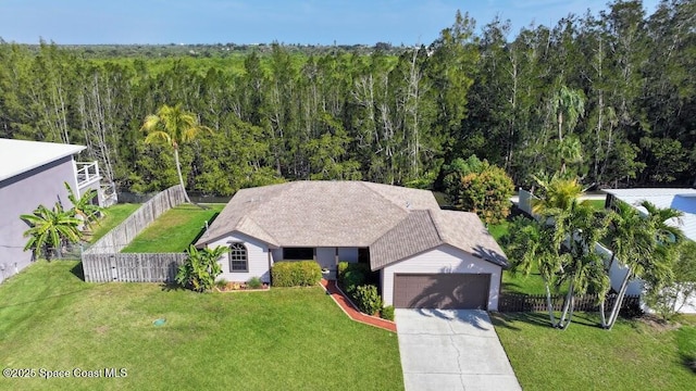 drone / aerial view with a wooded view