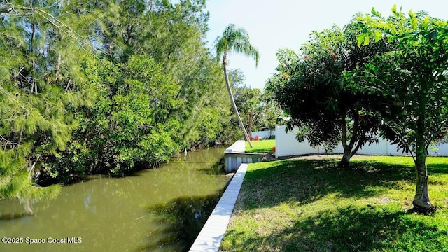 exterior space with a water view and a yard