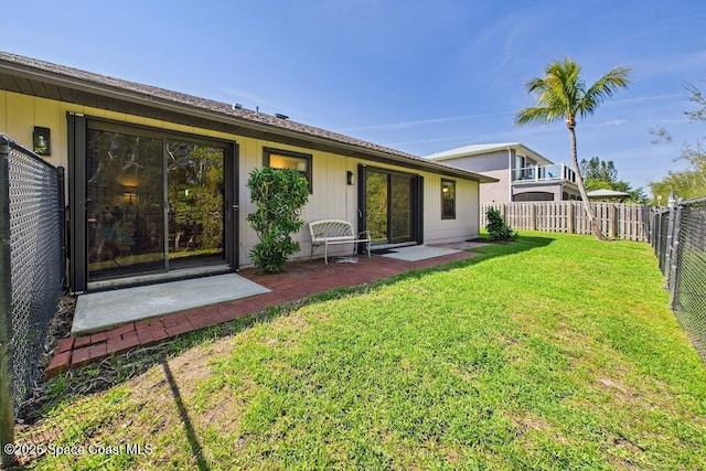 back of property featuring a patio area, a fenced backyard, and a yard