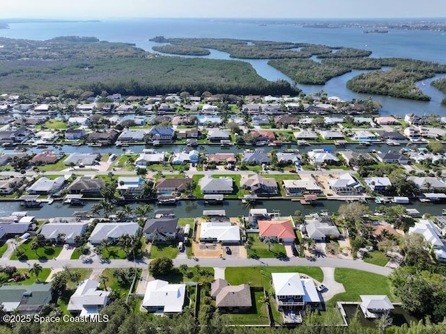 birds eye view of property featuring a water view and a residential view