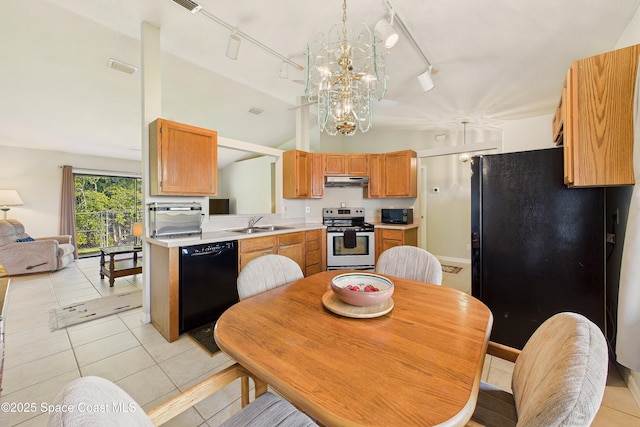 kitchen with light tile patterned floors, light countertops, vaulted ceiling, a sink, and black appliances