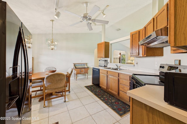 kitchen with lofted ceiling, under cabinet range hood, a sink, brown cabinets, and black appliances