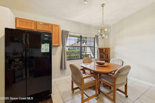 dining room with light tile patterned floors, baseboards, and an inviting chandelier