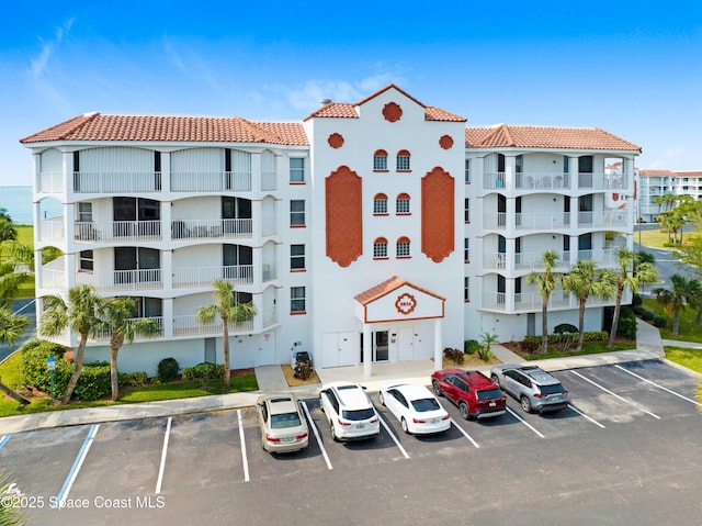 view of building exterior featuring uncovered parking