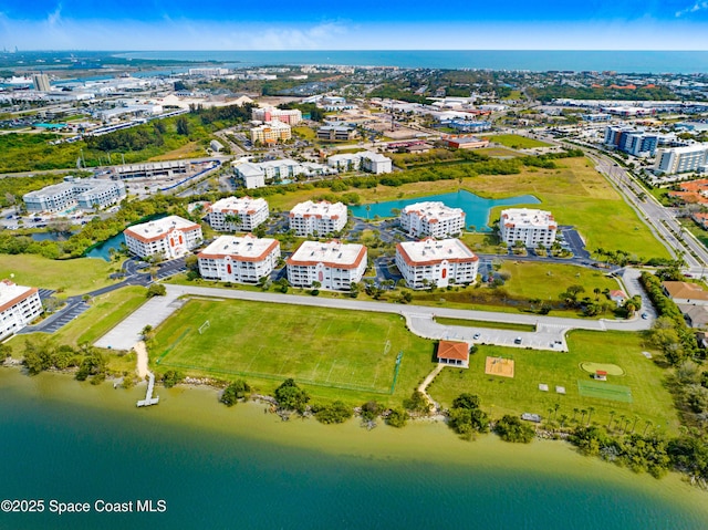 birds eye view of property featuring a water view and a city view