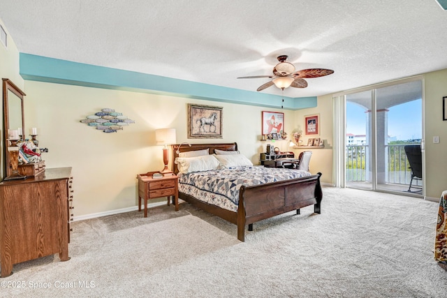 bedroom featuring a textured ceiling, carpet flooring, baseboards, access to outside, and floor to ceiling windows