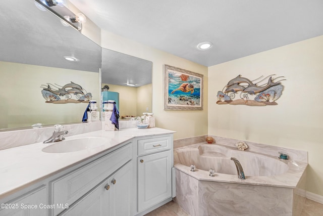 bathroom featuring tile patterned floors, a bath, and vanity