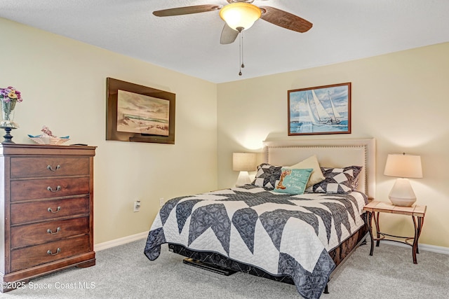 bedroom with light carpet, a ceiling fan, and baseboards