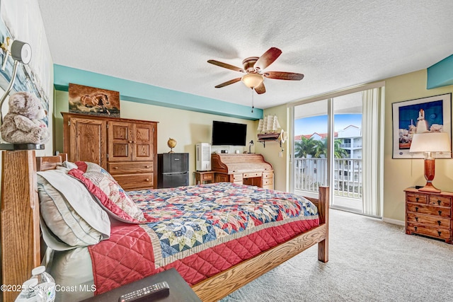 carpeted bedroom with a textured ceiling, ceiling fan, baseboards, access to outside, and a wall of windows