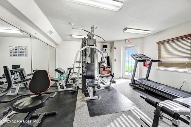 workout area featuring visible vents and a textured ceiling