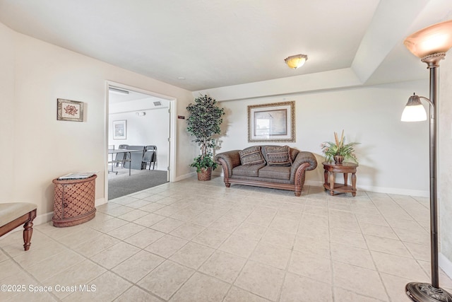 living area featuring light tile patterned floors and baseboards