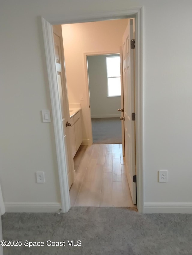 hallway featuring light carpet