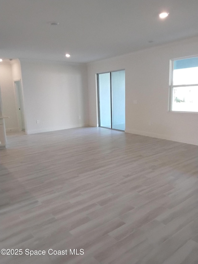 spare room with recessed lighting and light wood finished floors