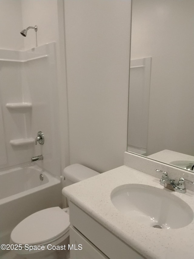 full bathroom featuring bathtub / shower combination, vanity, and toilet