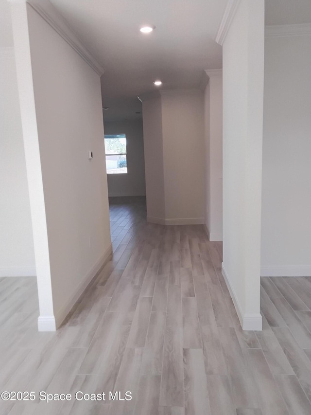 hall with ornamental molding, recessed lighting, baseboards, and light wood finished floors