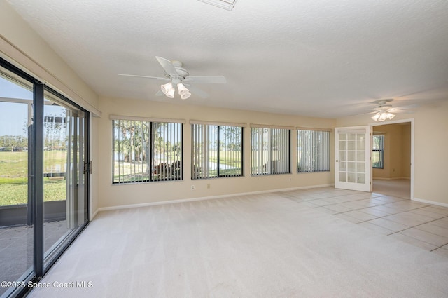 unfurnished sunroom with a ceiling fan